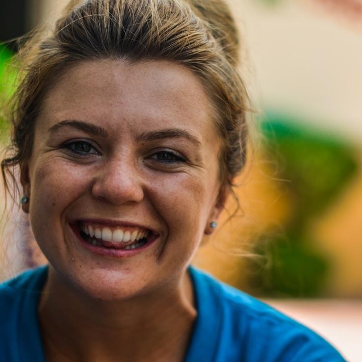 Kaveri Mehta, Lead Design Curator at Golden Meadow Collective, reviewing corporate floral arrangements